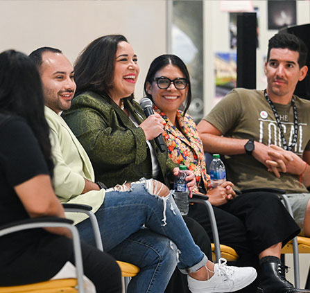 Photo of a person holding a microphone with a group of people. Link to Gifts of Real Estate. Photo of a person holding a microphone with a group of people. Link to Gifts of Real Estate.