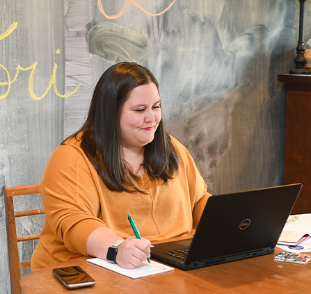 Photo of a person with a laptop. Link to Gifts by Estate Note.