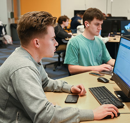 Photo of students working on computers. Link to Gifts of Appreciated Securities.